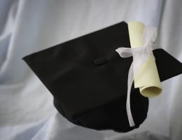 black graduation hat with scroll